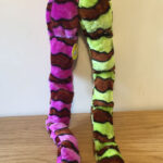 One purple and brown and one green and brown plush snakes